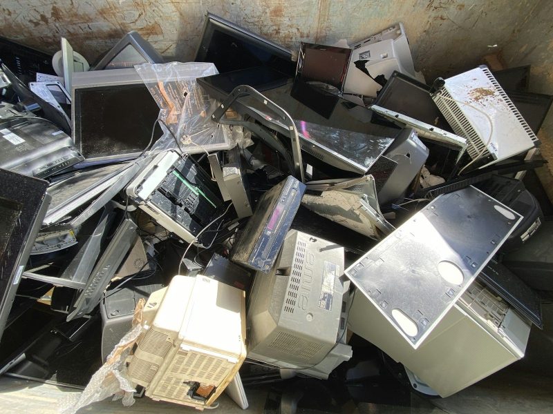 A pile of old computers, monitors and electronics ready for collection